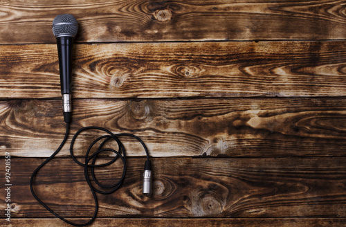 A microphone and headphones on a wooden background