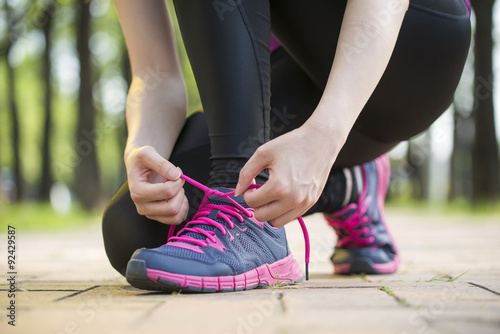 Asian young woman runner tying shoelaces healthy lifestyle © PR Image Factory