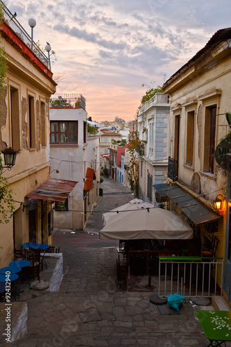 Fototapeta Naklejka Na Ścianę i Meble -  Morning street with coffee shops before opening. Image from the old town of Athens
