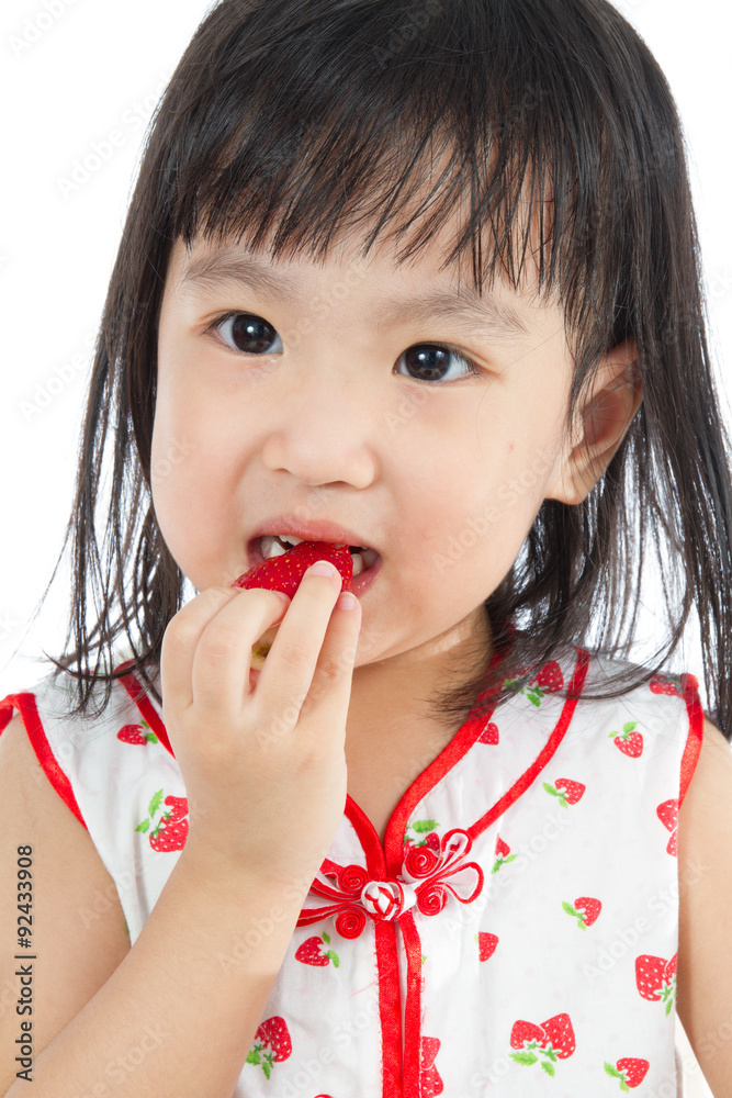 Asian Chinese little girl eating strawberries Asian Chinese little girl eating strawberries