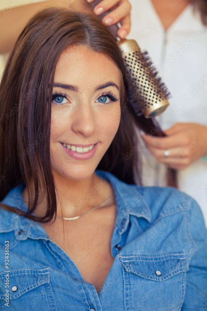 Fototapeta premium Hairdresser doing haircut for women in hairdressing salon. Concept photo.