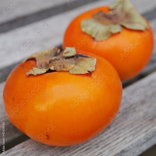 Two orange persimmon kaki fruits photo