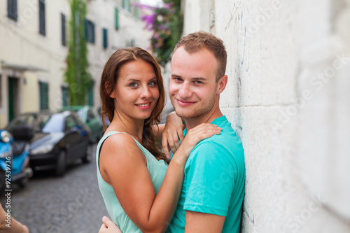 A couple standing on the street and having fun. Positive emotions.