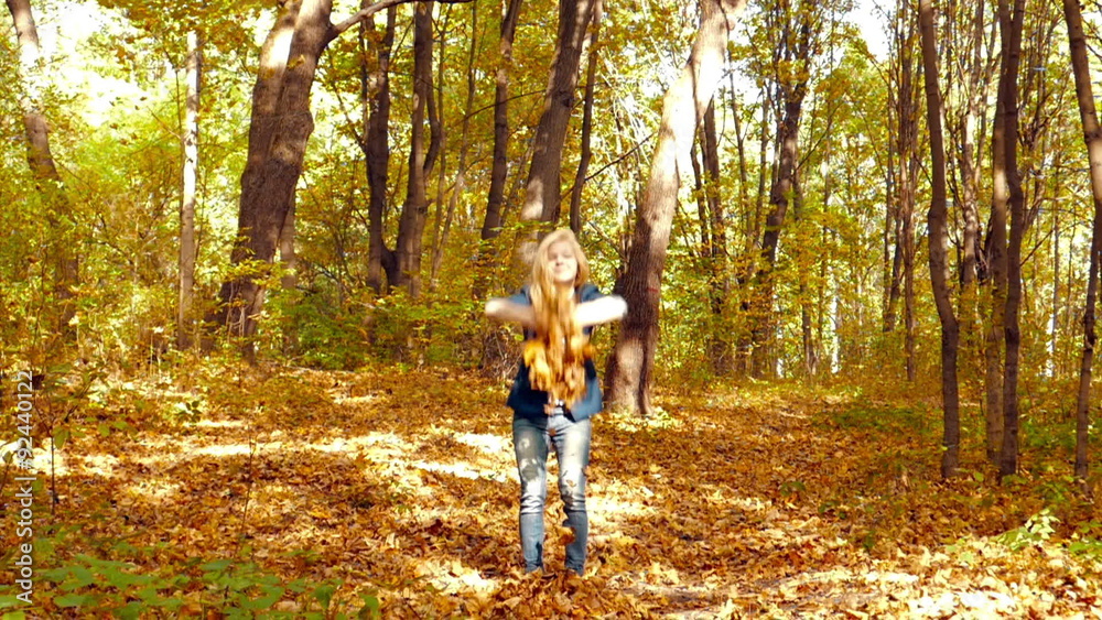 Girl throwing leaves in Autumn in slow motion Girl throwing leaves in Autumn in slow motion