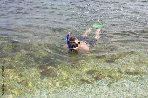 Boy swimming in the sea in mask, and fins
