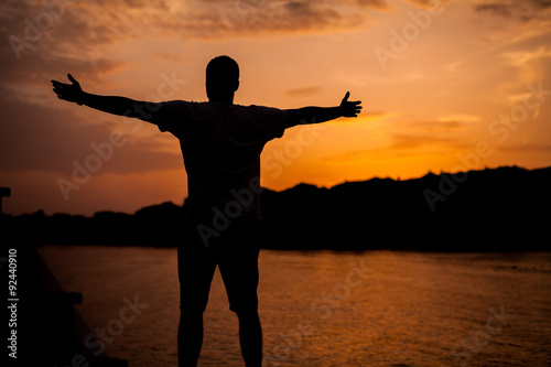 A man standing on the background of sunset