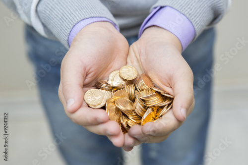 Handful of coins in palm hands