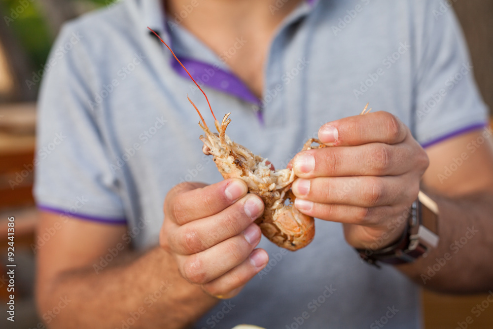 Men holding prawn in his hands.