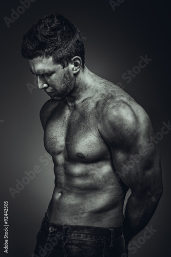 Dirty muscle man in pose on BW photo