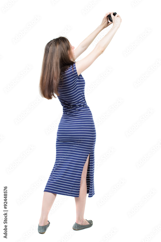 Back view of woman photographing. girl photographer in dress. Back view of woman photographing. girl photographer in dress.