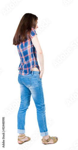 back view of standing young beautiful woman.