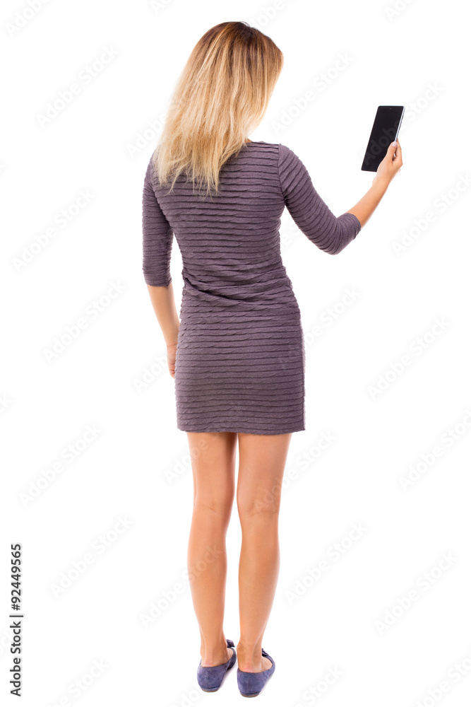 back view of standing young beautiful girl with tablet computer back view of standing young beautiful girl with tablet computer