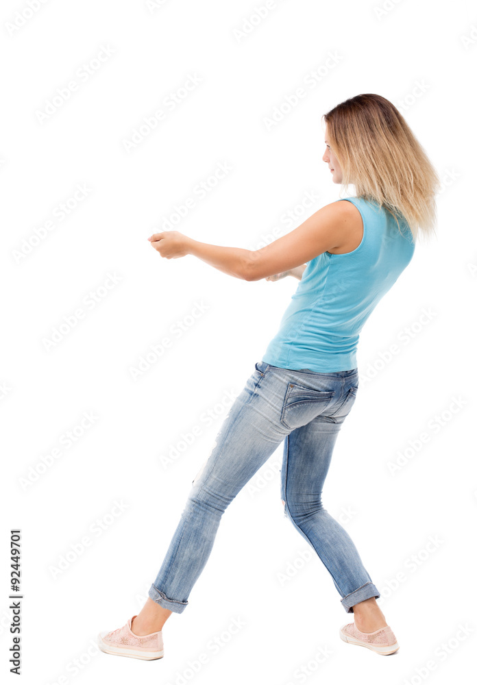 back view of standing girl pulling a rope from the top or cling back view of standing girl pulling a rope from the top or cling