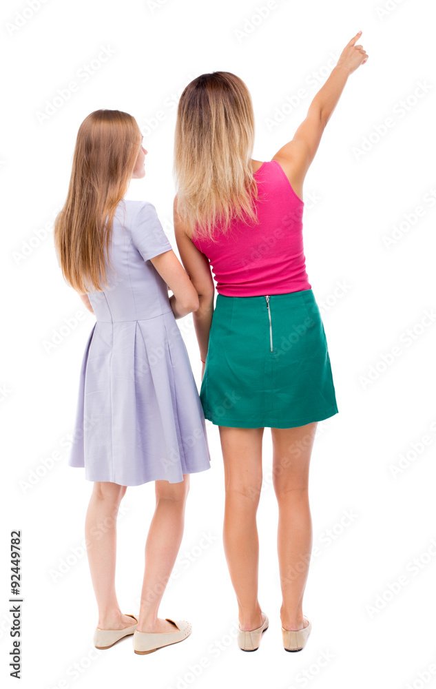 Back view of two pointing young girl.