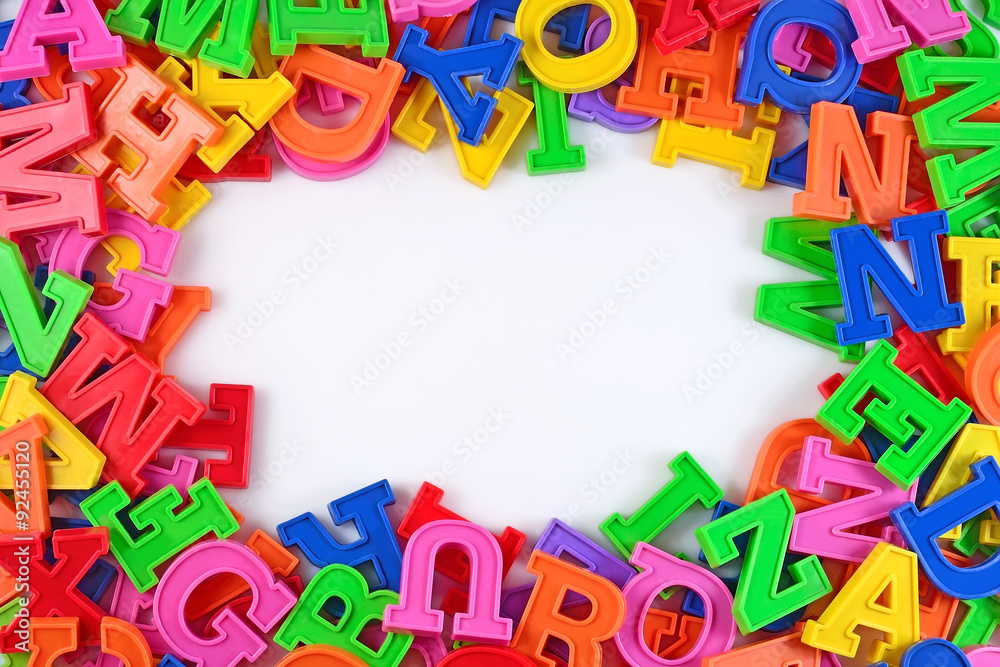 Frame of plastic colorful alphabet letters on a white