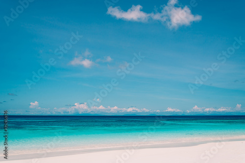 blue sky with sea and beach - soft focus with film filter