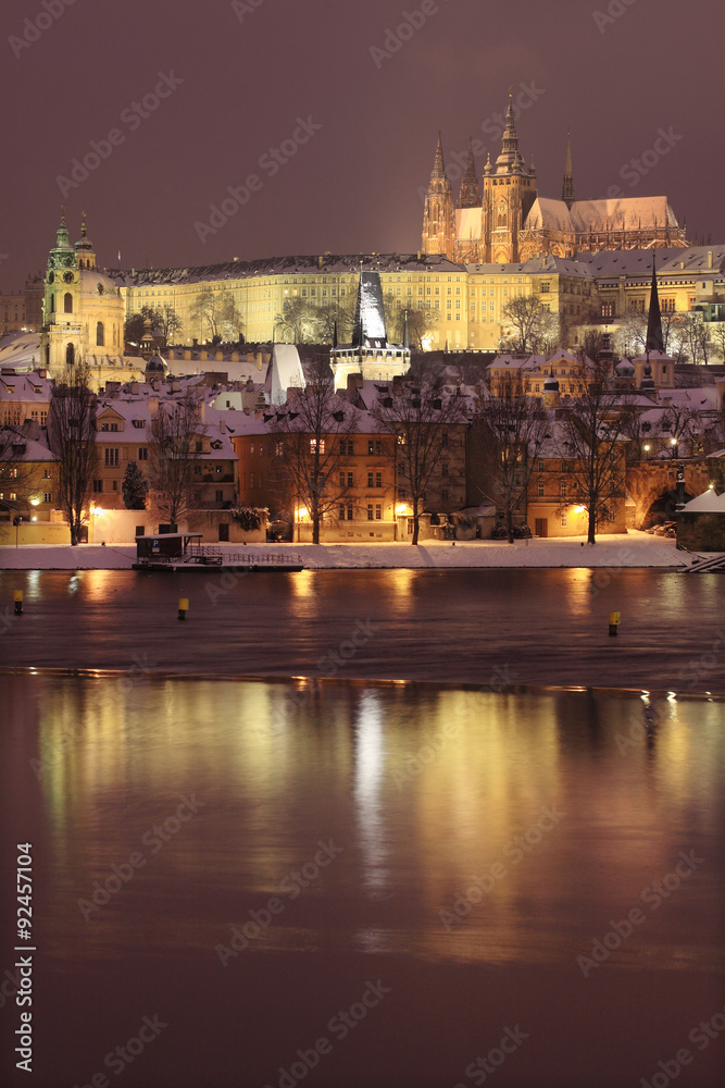 Fototapeta premium Night romantic colorful snowy Prague gothic Castle with Charles Bridge, Czech Republic