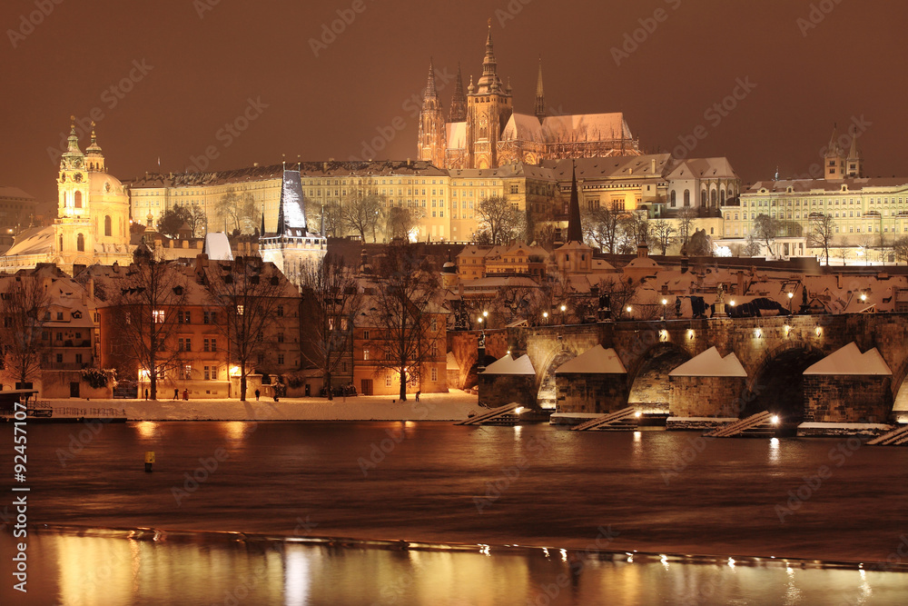 Obraz premium Night romantic colorful snowy Prague gothic Castle with Charles Bridge, Czech Republic