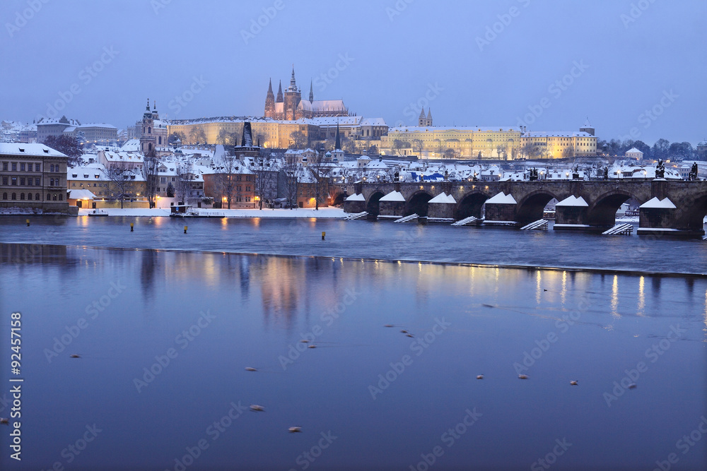 Night snowy Prague gothic Castle and Charles Bridge, Czech Republic