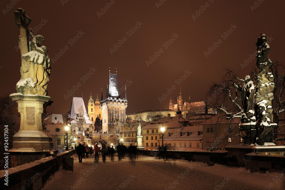 Night snowy Prague gothic Castle, Bridge Tower and St. Nicholas' Cathedral, Czech republic