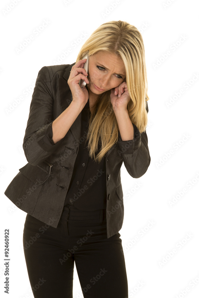 blond woman in black business attire talk on phone plug ear blond woman in black business attire talk on phone plug ear