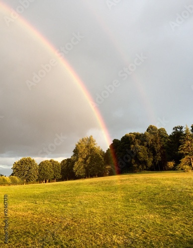 a rainbow touches the ground in a landscape