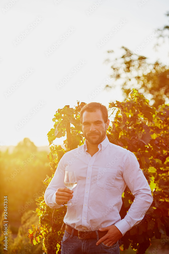 Man with a glass of white wine - obrazy, fototapety, plakaty 