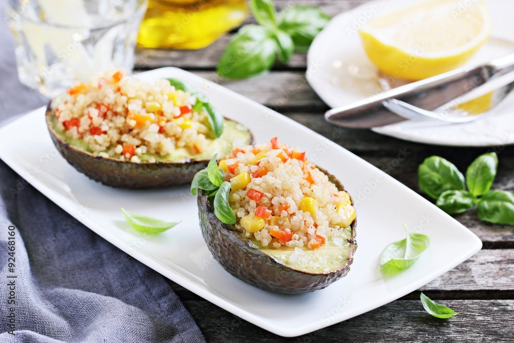 Grilled avocado staffed with quinoa vegetables salad.Selective focus Grilled avocado staffed with quinoa vegetables salad.Selective focus
