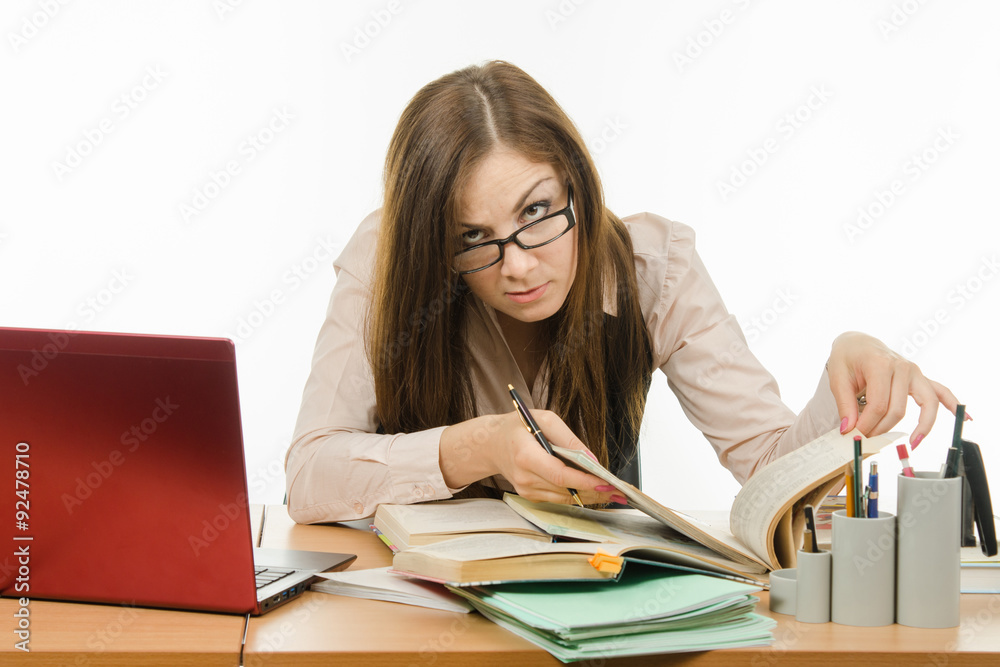 Teacher looking for information in a book Teacher looking for information in a book