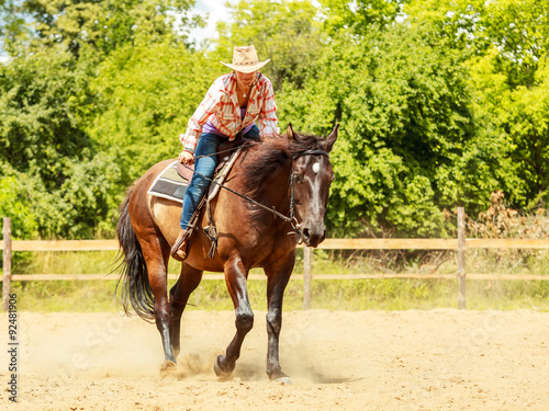 Western cowgirl woman riding horse. Sport activity © Voyagerix