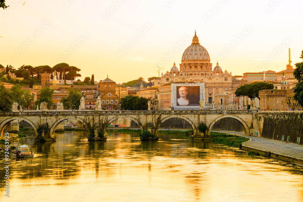 Rome and Vatican cityscape at sunset with bridge on the Tiber