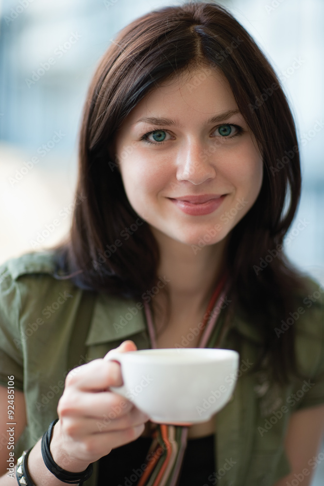 Beautiful and smiling woman with a cup of coffee Beautiful and smiling woman with a cup of coffee