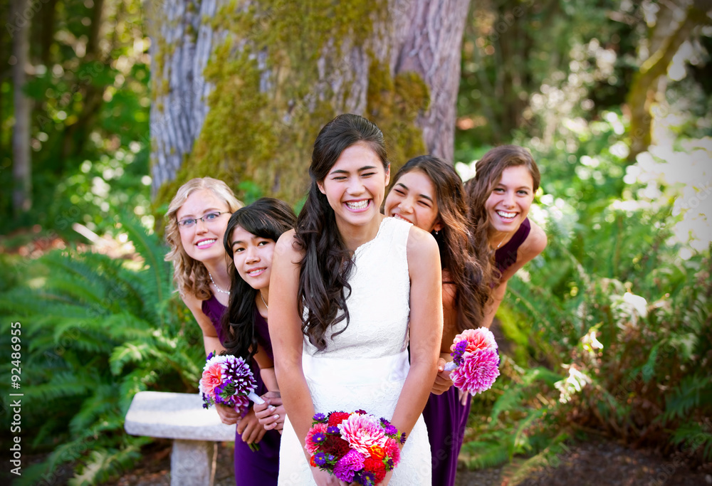 Beautiful biracial young bride smiling with her multiethnic grou Beautiful biracial young bride smiling with her multiethnic grou