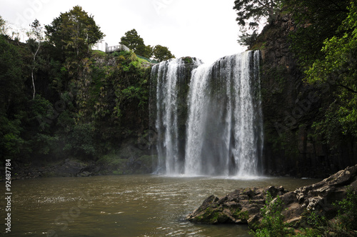 Whangarei falls from the river surface level on a cloudy day.