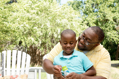 African American father and son. © pixelheadphoto