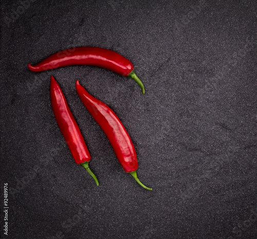 chili pepper on black stone background