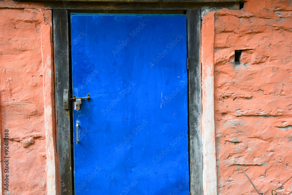 closed up the blue wood door with brick wall, in village Nepal