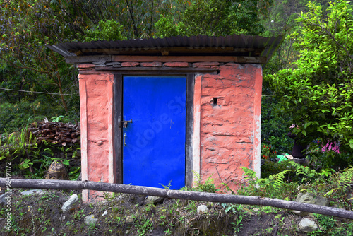 closed up the blue wood door with brick wall, in village Nepal