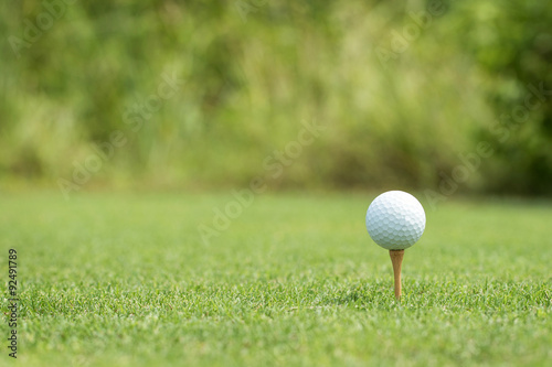 Golf ball on a wooden tee