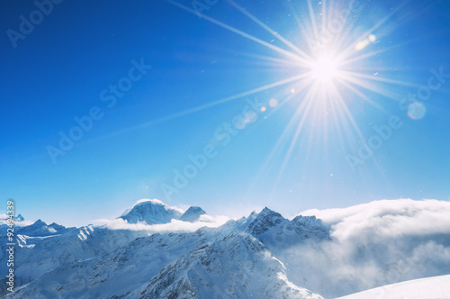 Winter snow-covered mountains at sunny day