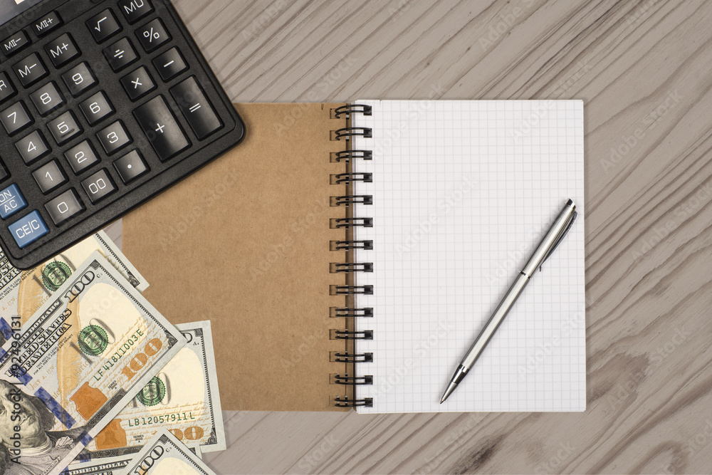 Money, calculator, notepad and pen on wooden background Money, calculator, notepad and pen on wooden background