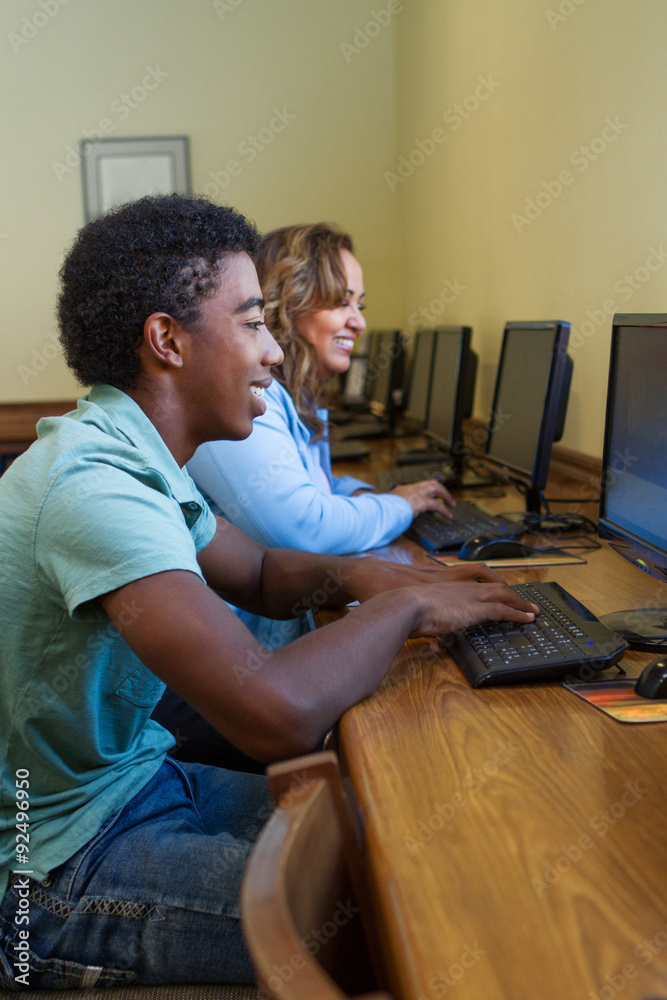 Students in the library working on computer Students in the library working on computer