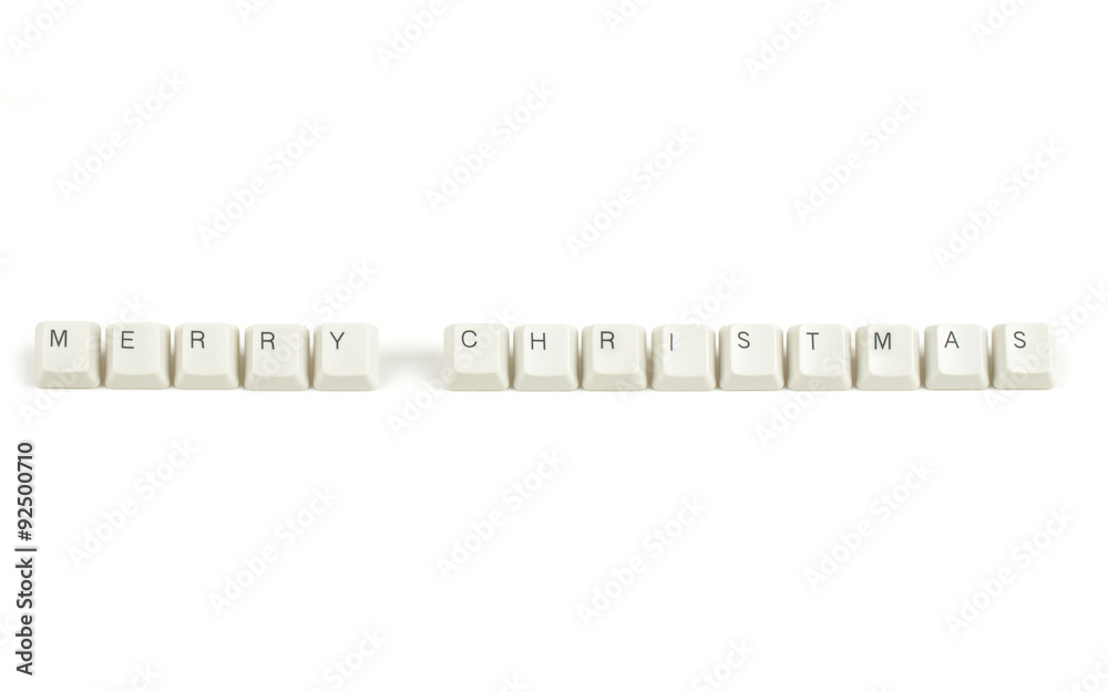 merry christmas from scattered keyboard keys on white