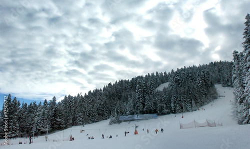 tourists skiing Ski resort Borovets, Bulgaria.Hotel complex and panorama of winter mountains
