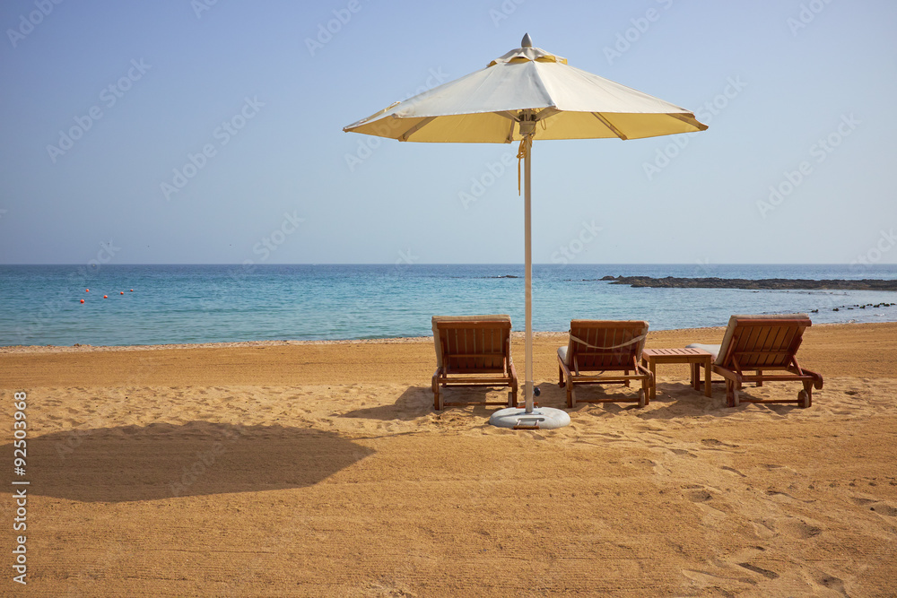 empty sun loungers on the beach