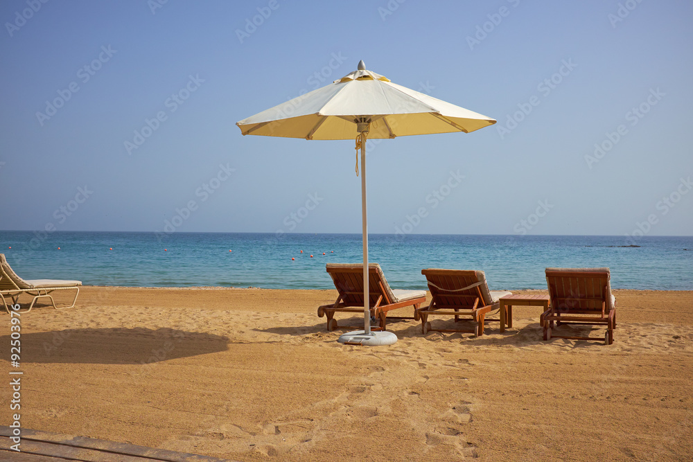 empty sun loungers on the beach