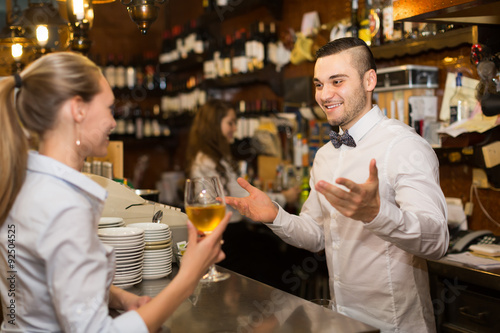 Girl flirting with barman at counter