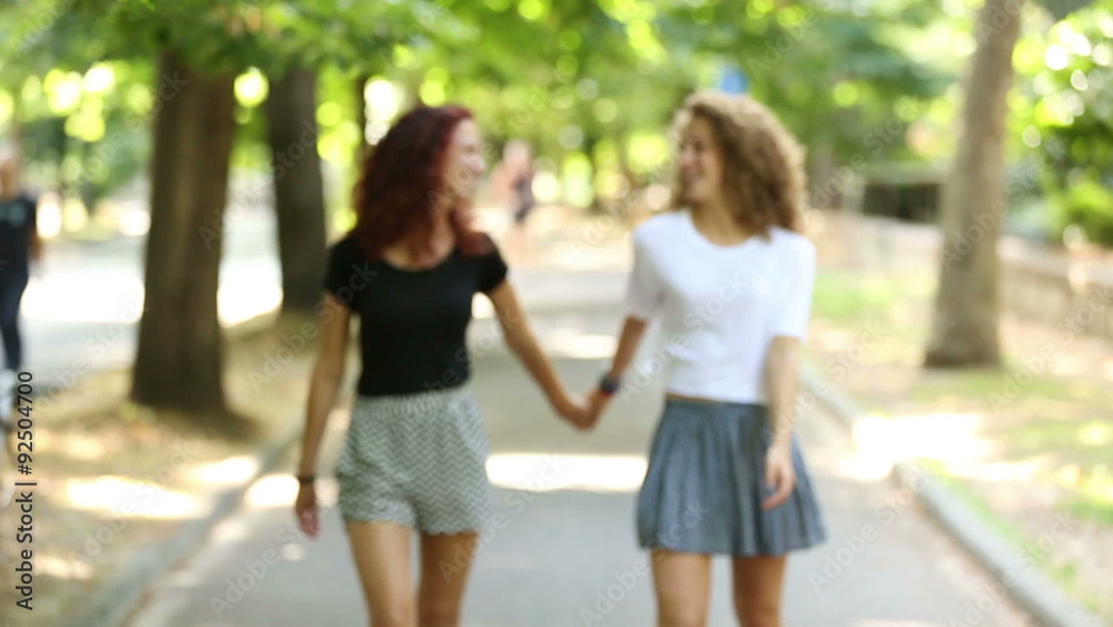 Two beautiful girls walking holding hands at park
Two beautiful girls walking holding hands at park