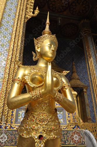 Golden statue of Kinare at Wat Phra Kaew or The Emerald Buddha temple in The Grand Palace Complex, Bangkok, Thailand. Kinare – mythological creature, half bird, half man