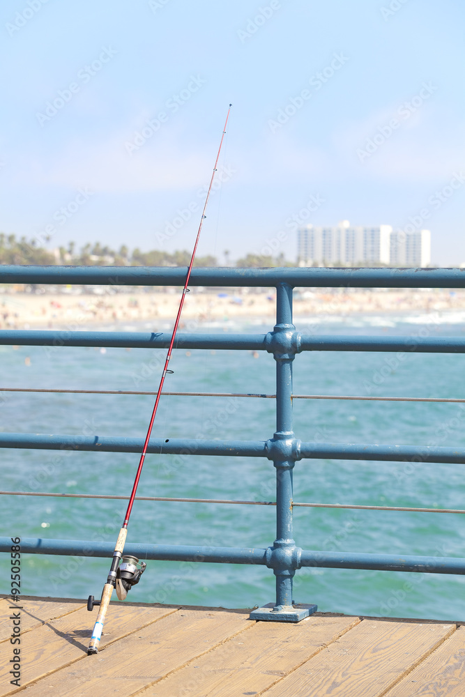 Fishing rod on pier, Santa Monica, USA.